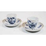 A pair of 19th century tea bowls and saucers, each underglaze blue decorated with birds and flowers