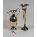 A small George V silver twin handled vase, on a loaded base, h.12cm; together with a silver