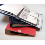 Three folders containing a quantity of first day covers, examples to include Royal Family and