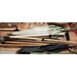 A collection of assorted parasols and walking sticks