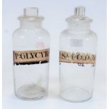 Two 19th century glass apothecary jars and stoppers, one titled P: Sapo. Dur, and the other P: