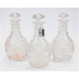 A set of three circa 1830 cut glass triple ring neck mallet decanters, with mushroom stoppers and