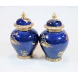 A pair of early 20th century A.G. Harley-Jones Wilton ware blue lustre vases and covers, each with