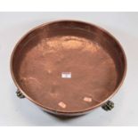 A hammered copper preserve pan with brass lion paw feet, dia. 37cm