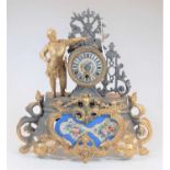 A Louis XV style gilt metal and porcelain inset mantel clock, the case adorned with a lone