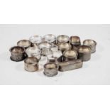 A set of five George V silver napkin rings of plain undecorated form within gadrooned border,