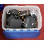 A box of assorted cameras, binoculars, and associated accessories