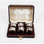 A set of six Edwardian silver napkin rings, each with floral engraved decoration and numbered 1-6 by