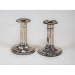 A pair of George V silver dwarf table candlesticks, each of octagonal form, on weighted base, by