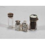 A George V scent bottle having a cylindrical silver body the white metal mount with cloisonné