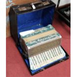 A Pietro piano accordion having faux mother of pearl keys and jewelled case, the whole in original