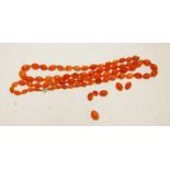 Two beaded and graduated orange glass necklaces