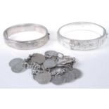 Two modern silver hinged bangles; together with a threepenny bit set bracelet (3)