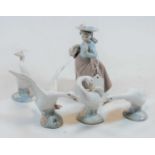 A Nao Spanish porcelain figure of a girl, wearing a hat and with basket in hand; together with