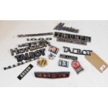 A collection of assorted car model badges to include Triumph Herald 1360, Skoda, Marina, Talbot etc
