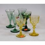 A small collection of glassware, to include a pair of yellow tinted liqueur glasses, each having a