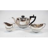 A George V silver bachelors three-piece tea service, comprising teapot, sugar and milk jug, of