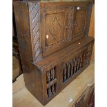 A joined oak hanging food cupboard, having twin upper panelled doors over a single spindle turned