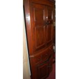 A 19th century oak and elm freestanding bowfront corner cupboard, having twin panelled upper doors