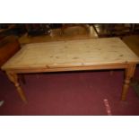 A modern pine round cornered farmhouse kitchen table, raised on turned supports, length 179cm