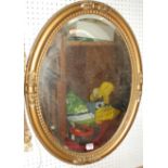 A gilt decorated bevelled oval wall mirror, 70 x 55cm