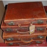Four various small vintage leather suit and brief cases, the largest width 50cm