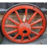 A red painted wood and cast iron bound single cart wheel, dia. 89cm