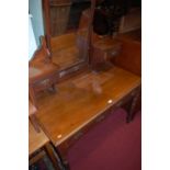 An Edwardian walnut swing mirrorback dressing table, having twin frieze drawers and raised on ring