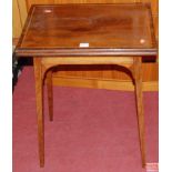 An Edwardian mahogany, rosewood crossbanded, and satinwood strung swivel fold-over games table,