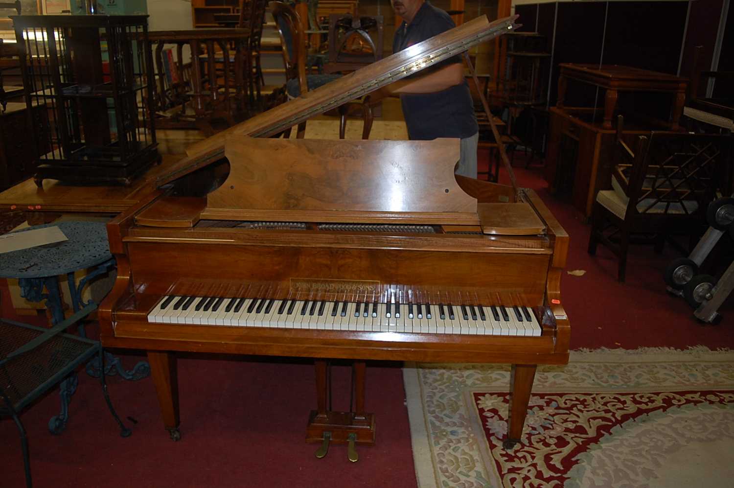 An early 20th century figured walnut cased baby grand piano by John Broadwood & Sons, iron framed