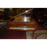 An early 20th century figured walnut cased baby grand piano by John Broadwood & Sons, iron framed