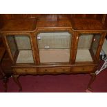 A good 1920s figured walnut and crossbanded side cabinet, having three glazed upper doors over three