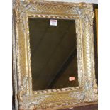 A reproduction gilt composition framed wall mirror, 42 x 37cm