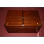 A contemporary hardwood hinge top blanket box, having iron end carry handles, width 83cm