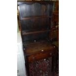 A 19th century provincial oak narrow dresser, the open plate rack over single long frieze drawer