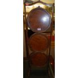 A 1930s walnut and figured walnut circular three-tier folding cake stand