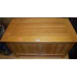 A contemporary light oak hinge topped twin panelled blanket box, w.90cm