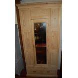 A pine single mirrored door wardrobe, having single long lower drawer, width 102cm