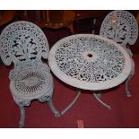 A distressed painted cast and pierced galvanised metal garden circular table, with two matching