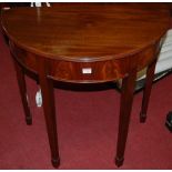 A contemporary mahogany and flame mahogany demi-lune side table, raised on square tapering