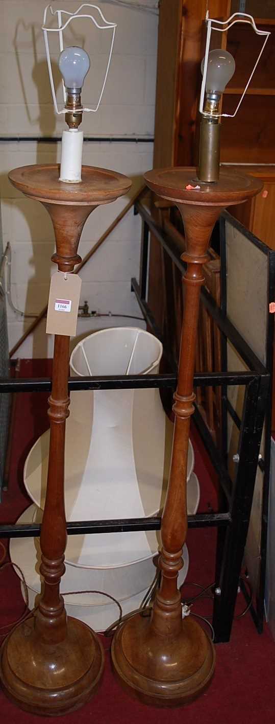 A pair of early 20th century turned walnut standard lamps with shades, each height (excluding