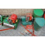 Two vintage petrol driven lawn mowers, each with grass collecting box