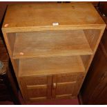 A joined and limed oak low bookshelf, having twin cupboard lower doors, w.60.5cm