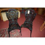 A set of six black painted cast and pierced galvanised metal garden chairs
