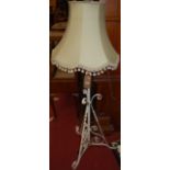 An early 20th century and later white painted wrought iron standard lamp, having telescopic action