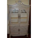 A contemporary French distressed painted side cupboard, having twin glazed upper doors over