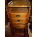 A contemporary walnut and brass bound campaign style bedside chest, having two drawers, open