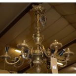 A French cast and gilt brass hanging eight light electrolier, with rams head masked scroll branches,