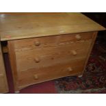 A contemporary pine low chest, of two short over two long drawers, with turned knob handles, w.