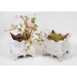 *A pair of Victorian cast iron jardinieres, each of bellied square section, cast with swags of